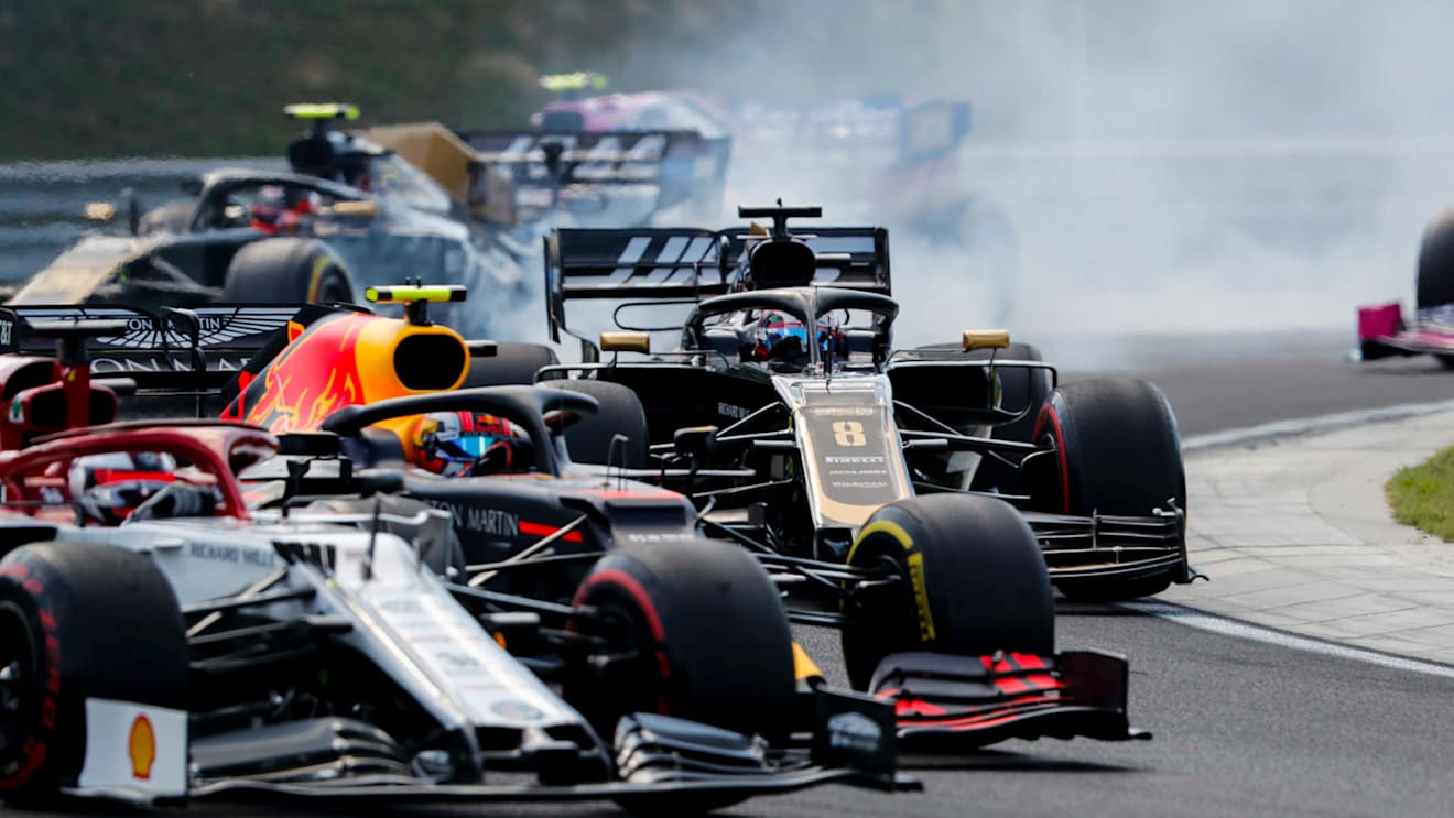 HUNGARORING, HUNGARY - AUGUST 04: Kimi Raikkonen, Alfa Romeo Racing C38, battles with Pierre Gasly, Red Bull Racing RB15, and Romain Grosjean, Haas VF-19, at the start during the Hungarian GP at Hungaroring on August 04, 2019 in Hungaroring, Hungary. (Photo by Steven Tee / LAT Images)