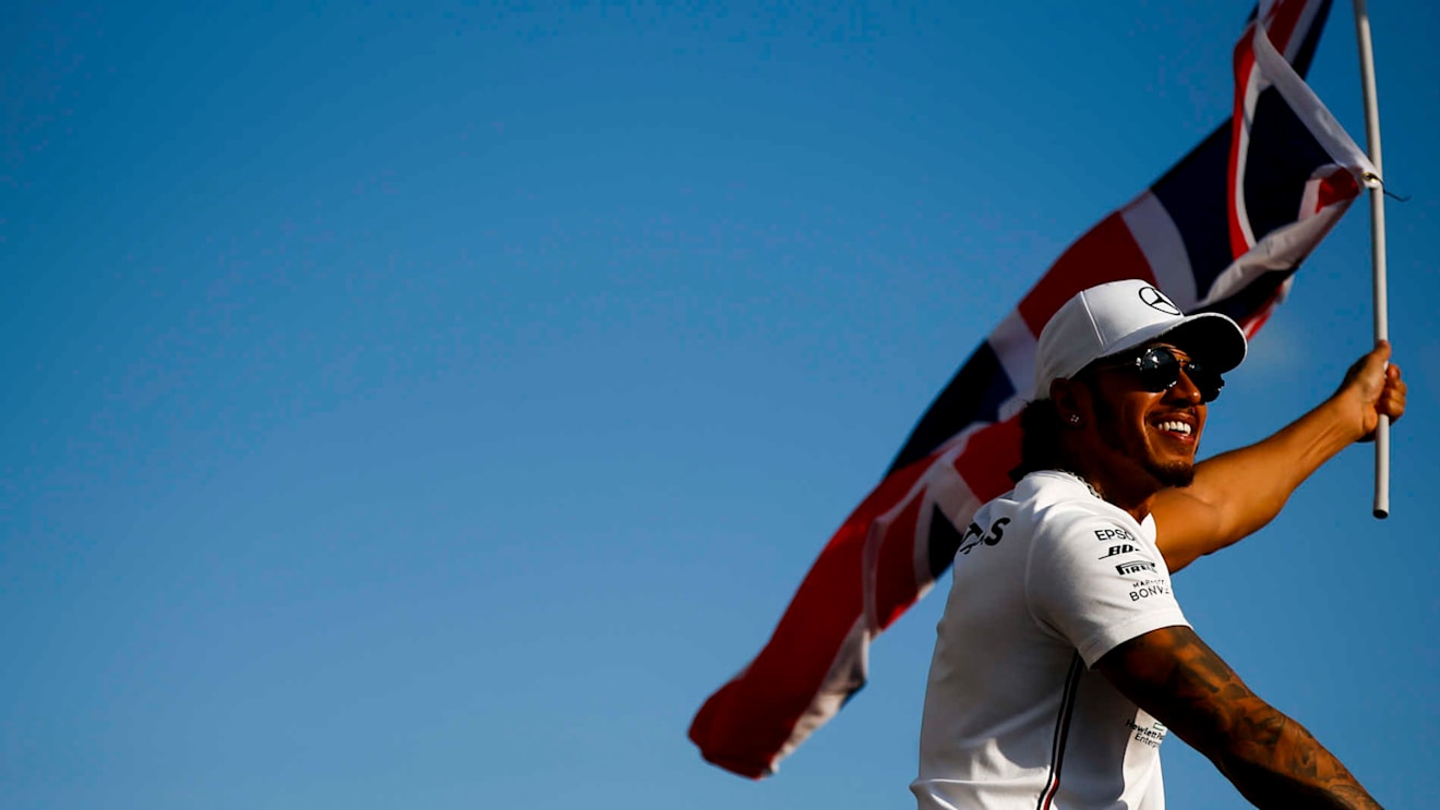 HUNGARORING, HUNGARY - AUGUST 04: Race winner Lewis Hamilton, Mercedes AMG F1 celebrates with a flag during the Hungarian GP at Hungaroring on August 04, 2019 in Hungaroring, Hungary. (Photo by Andy Hone / LAT Images)