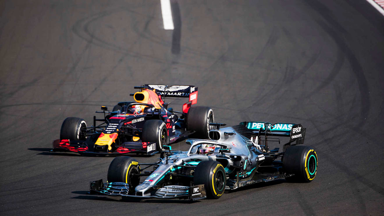 HUNGARORING, HUNGARY - AUGUST 04: Lewis Hamilton, Mercedes AMG F1 W10, passes Max Verstappen, Red Bull Racing RB15, for the lead during the Hungarian GP at Hungaroring on August 04, 2019 in Hungaroring, Hungary. (Photo by Sam Bloxham / LAT Images)