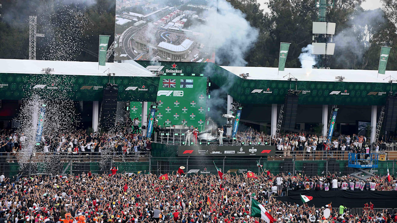 MEXICO CITY, MEXICO - OCTOBER 27: A general view as race winner Lewis Hamilton of Great Britain and Mercedes GP, second placed Sebastian Vettel of Germany and Ferrari and third placed Valtteri Bottas of Finland and Mercedes GP celebrate on the podium during the F1 Grand Prix of Mexico at Autodromo Hermanos Rodriguez on October 27, 2019 in Mexico City, Mexico. (Photo by Charles Coates/Getty Images)