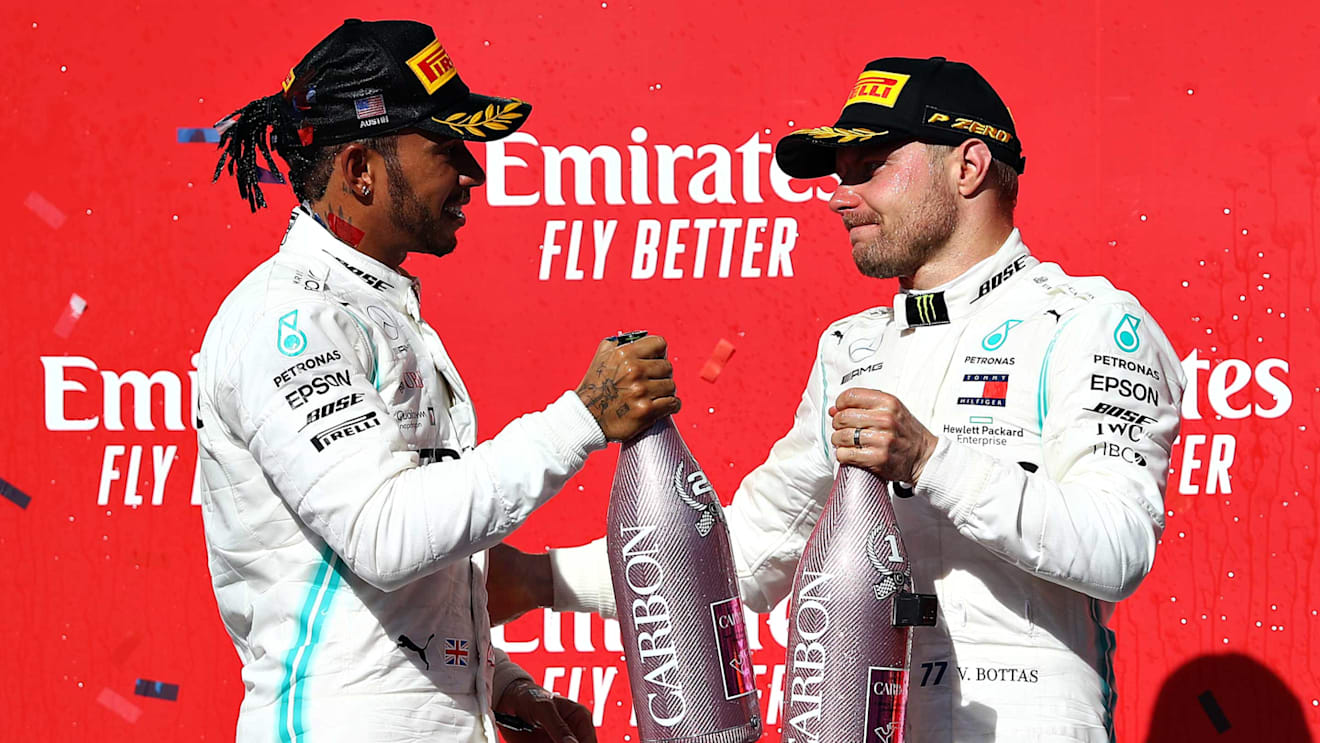 AUSTIN, TEXAS - NOVEMBER 03: 2019 Formula One World Drivers Champion Lewis Hamilton of Great Britain and Mercedes GP and race winner Valtteri Bottas of Finland and Mercedes GP celebrate on the podium during the F1 Grand Prix of USA at Circuit of The Americas on November 03, 2019 in Austin, Texas. (Photo by Mark Thompson/Getty Images)