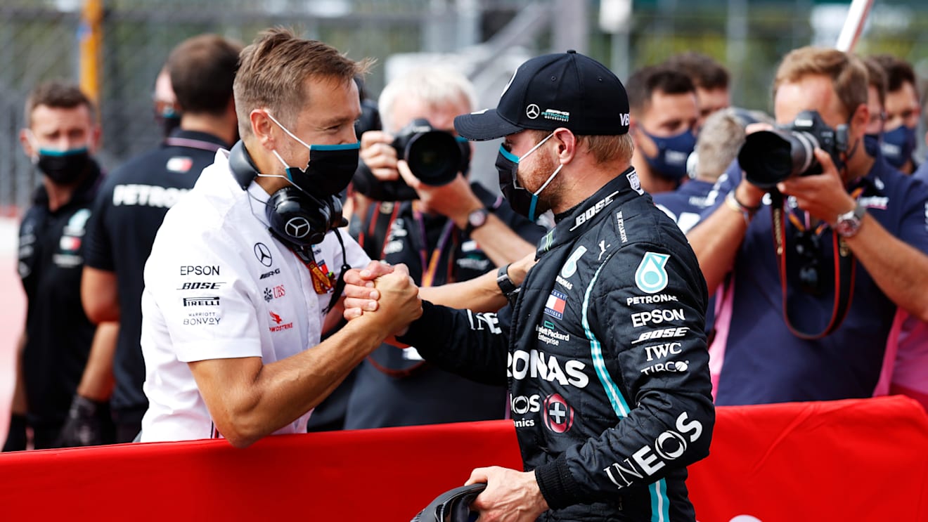 NORTHAMPTON, ENGLAND - AUGUST 08: Pole position qualifier Valtteri Bottas of Finland and Mercedes GP celebrates with a team member in parc ferme during qualifying for the F1 70th Anniversary Grand Prix at Silverstone on August 08, 2020 in Northampton, England. (Photo by Andrew Boyers/Pool via Getty Images)