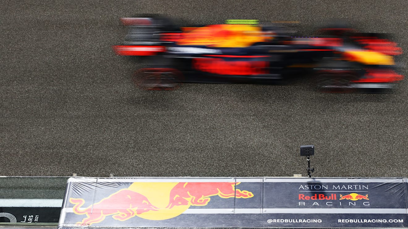ABU DHABI, UNITED ARAB EMIRATES - DECEMBER 12: Alexander Albon of Thailand driving the (23) Aston Martin Red Bull Racing RB16 passes the Red Bull Racing pitwall during qualifying ahead of the F1 Grand Prix of Abu Dhabi at Yas Marina Circuit on December 12, 2020 in Abu Dhabi, United Arab Emirates. (Photo by Mark Thompson/Getty Images)