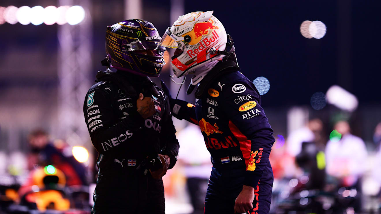 ABU DHABI, UNITED ARAB EMIRATES - DECEMBER 12: Pole position qualifier Max Verstappen of Netherlands and Red Bull Racing is congratulated by third placed qualifier Lewis Hamilton of Great Britain and Mercedes GP in parc ferme during qualifying ahead of the F1 Grand Prix of Abu Dhabi at Yas Marina Circuit on December 12, 2020 in Abu Dhabi, United Arab Emirates. (Photo by Mario Renzi - Formula 1/Formula 1 via Getty Images)