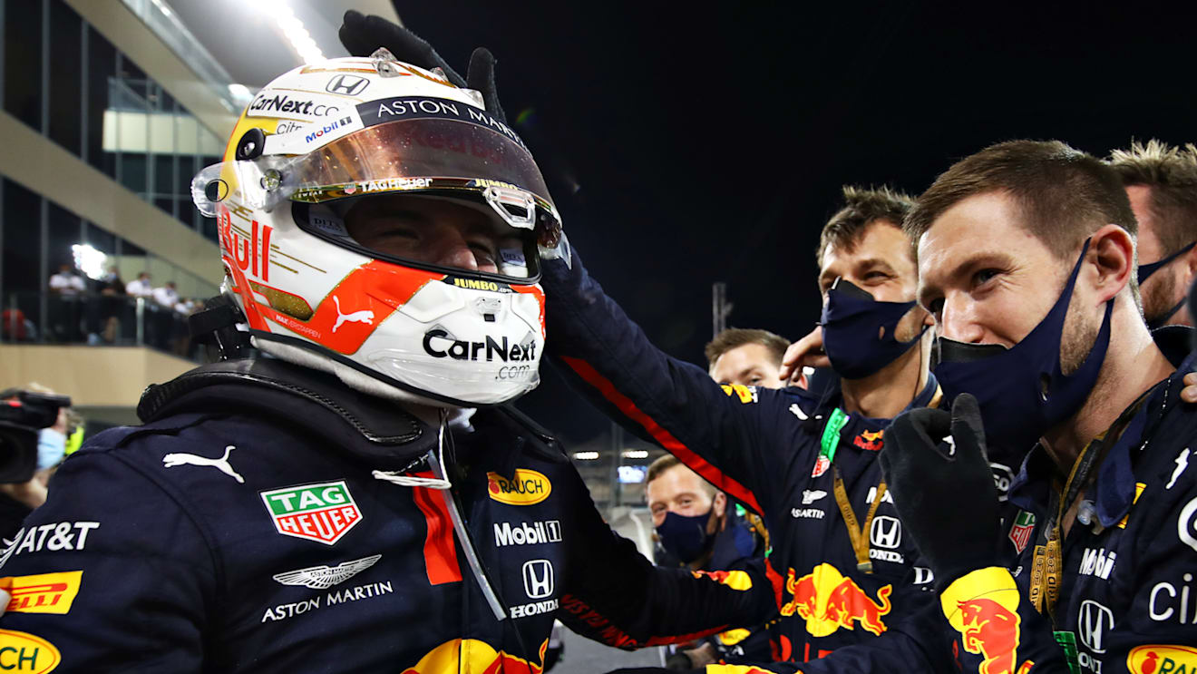 ABU DHABI, UNITED ARAB EMIRATES - DECEMBER 13: Race winner Max Verstappen of Netherlands and Red Bull Racing celebrates with his team in parc ferme during the F1 Grand Prix of Abu Dhabi at Yas Marina Circuit on December 13, 2020 in Abu Dhabi, United Arab Emirates. (Photo by Mark Thompson/Getty Images)