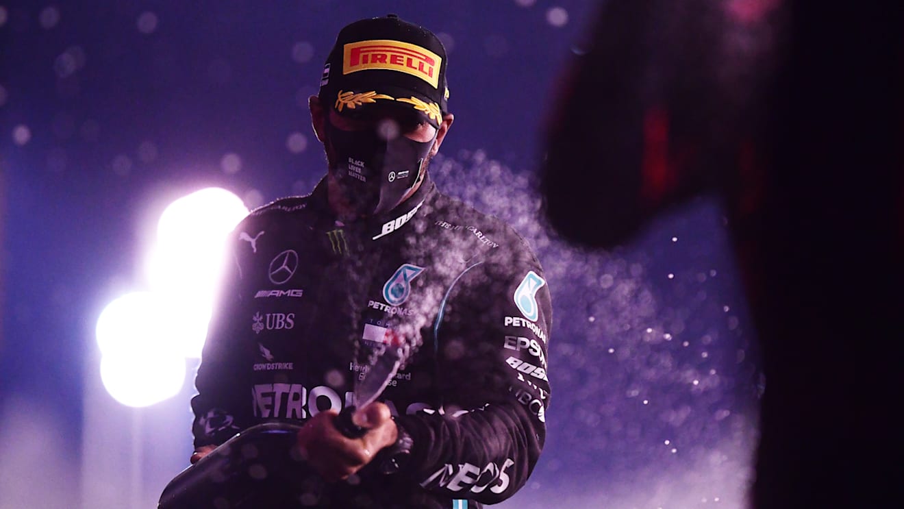 ABU DHABI, UNITED ARAB EMIRATES - DECEMBER 13: Third placed Lewis Hamilton of Great Britain and Mercedes GP celebrates on the podium during the F1 Grand Prix of Abu Dhabi at Yas Marina Circuit on December 13, 2020 in Abu Dhabi, United Arab Emirates. (Photo by Mario Renzi - Formula 1/Formula 1 via Getty Images)