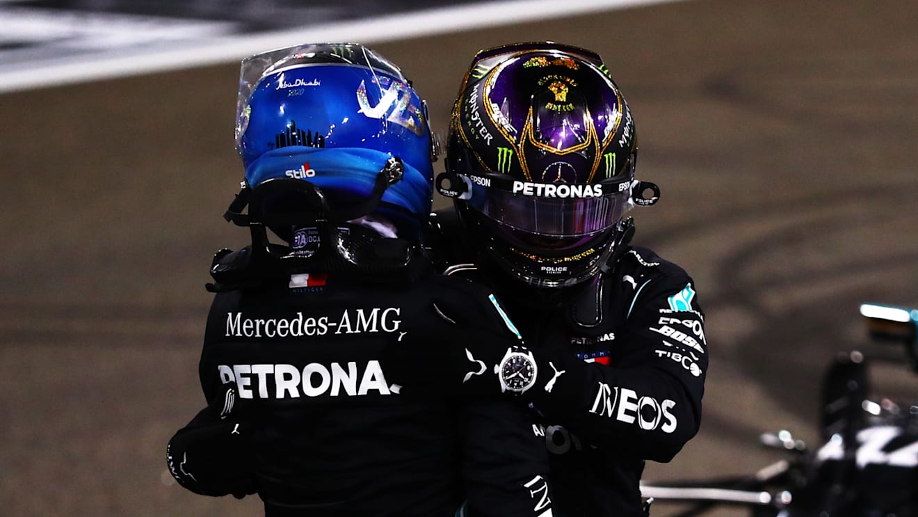 ABU DHABI, UNITED ARAB EMIRATES - DECEMBER 13: Second placed Valtteri Bottas of Finland and Mercedes GP and third placed Lewis Hamilton of Great Britain and Mercedes GP hug in parc ferme during the F1 Grand Prix of Abu Dhabi at Yas Marina Circuit on December 13, 2020 in Abu Dhabi, United Arab Emirates. (Photo by Dan Istitene - Formula 1/Formula 1 via Getty Images)