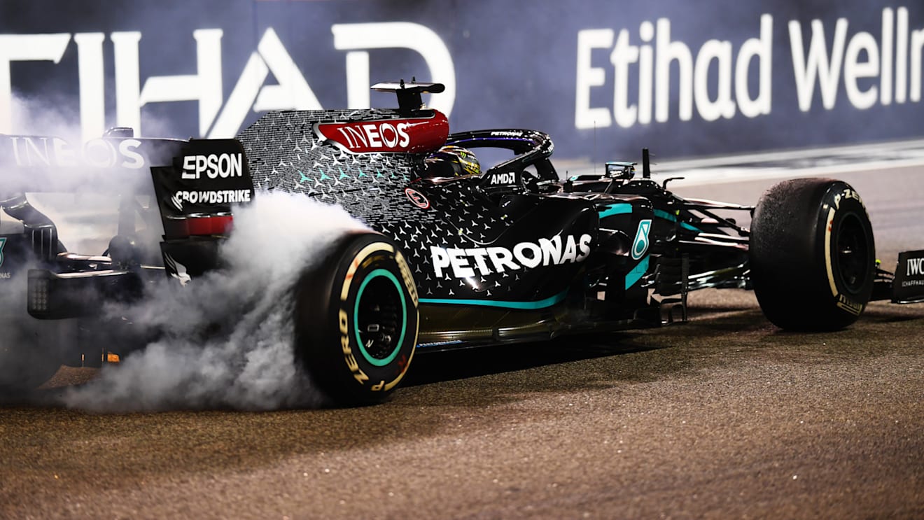 ABU DHABI, UNITED ARAB EMIRATES - DECEMBER 13: Third placed Lewis Hamilton of Great Britain driving the (44) Mercedes AMG Petronas F1 Team Mercedes W11 does donuts after the F1 Grand Prix of Abu Dhabi at Yas Marina Circuit on December 13, 2020 in Abu Dhabi, United Arab Emirates. (Photo by Clive Mason - Formula 1/Formula 1 via Getty Images)