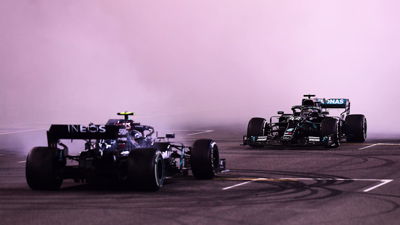 ABU DHABI, UNITED ARAB EMIRATES - DECEMBER 13: Second placed Valtteri Bottas of Finland and Mercedes GP and third placed Lewis Hamilton of Great Britain and Mercedes GP perform donuts following the F1 Grand Prix of Abu Dhabi at Yas Marina Circuit on December 13, 2020 in Abu Dhabi, United Arab Emirates. (Photo by Mario Renzi - Formula 1/Formula 1 via Getty Images)