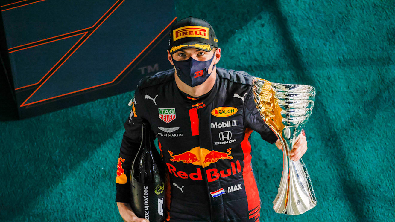 ABU DHABI, UNITED ARAB EMIRATES - DECEMBER 13: Race winner Max Verstappen of Netherlands and Red Bull Racing celebrates on the podium during the F1 Grand Prix of Abu Dhabi at Yas Marina Circuit on December 13, 2020 in Abu Dhabi, United Arab Emirates. (Photo by Peter Fox/Getty Images)