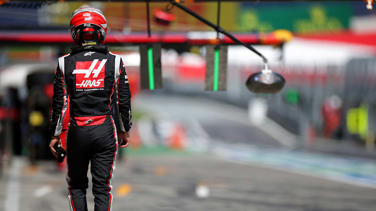 SPIELBERG, AUSTRIA - JULY 04:  Kevin Magnussen of Denmark and Haas F1 walks through the pit lane during qualifying for the Formula One Grand Prix of Austria at Red Bull Ring on July 04, 2020 in Spielberg, Austria. (Photo by Peter Fox/Getty Images)