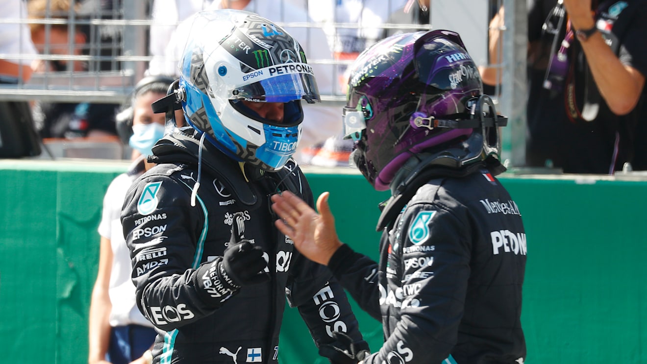 SPIELBERG, AUSTRIA - JULY 04: Pole position qualifier Valtteri Bottas of Finland and Mercedes GP shakes hands with second place qualifier and teammate Lewis Hamilton of Great Britain and Mercedes GP in parc ferme after qualifying for the Formula One Grand Prix of Austria at Red Bull Ring on July 04, 2020 in Spielberg, Austria. (Photo by Leonhard Foeger/Pool via Getty Images)