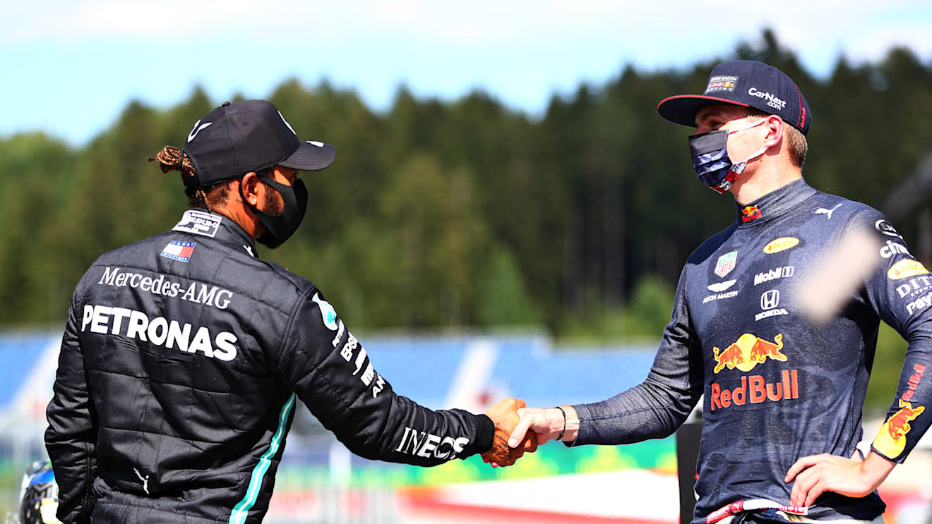 SPIELBERG, AUSTRIA - JULY 04: Second place qualifier Lewis Hamilton of Great Britain and Mercedes GP and third place qualifier Max Verstappen of Netherlands and Red Bull Racing shake hands in parc ferme during qualifying for the Formula One Grand Prix of Austria at Red Bull Ring on July 04, 2020 in Spielberg, Austria. (Photo by Dan Istitene - Formula 1/Formula 1 via Getty Images)