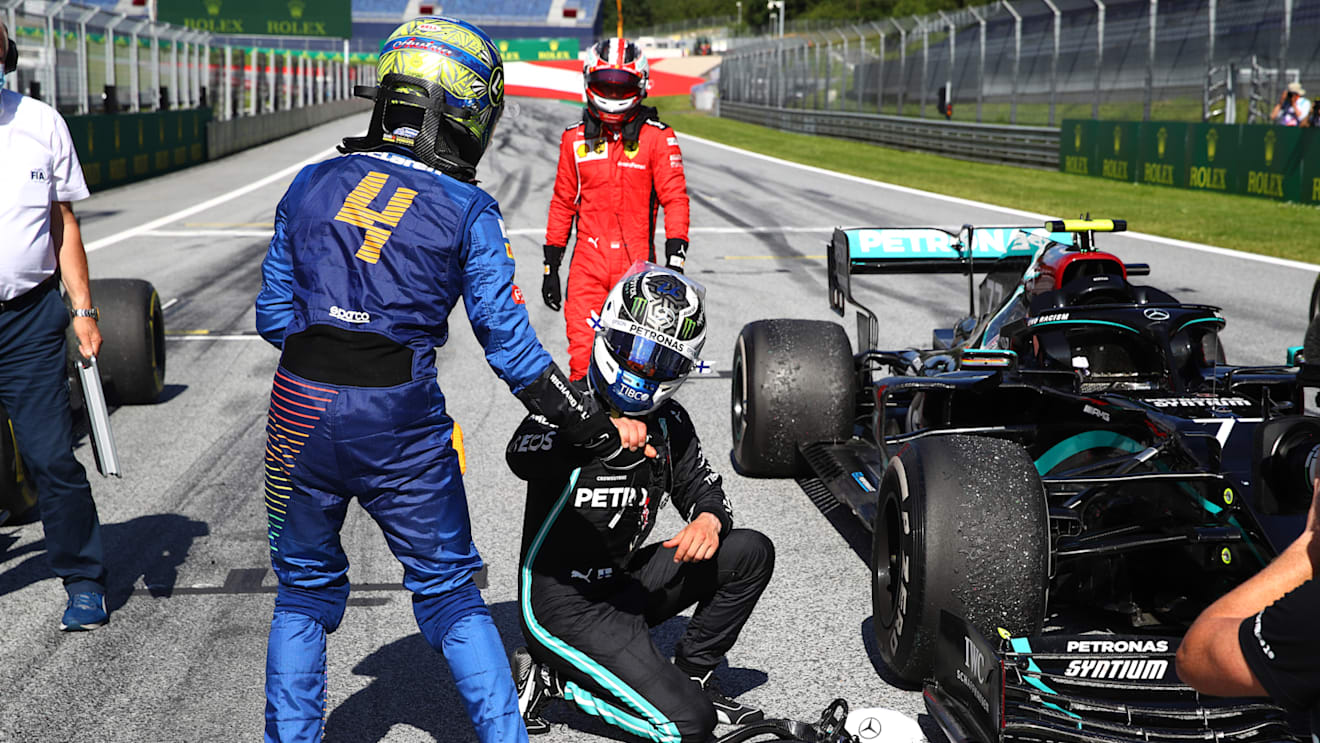 SPIELBERG, AUSTRIA - JULY 05: Race winner Valtteri Bottas of Finland driving the (77) Mercedes AMG Petronas F1 Team Mercedes W11  interacts with third placed Lando Norris of Great Britain and McLaren F1 during the Formula One Grand Prix of Austria at Red Bull Ring on July 05, 2020 in Spielberg, Austria. (Photo by Mark Thompson/Getty Images)