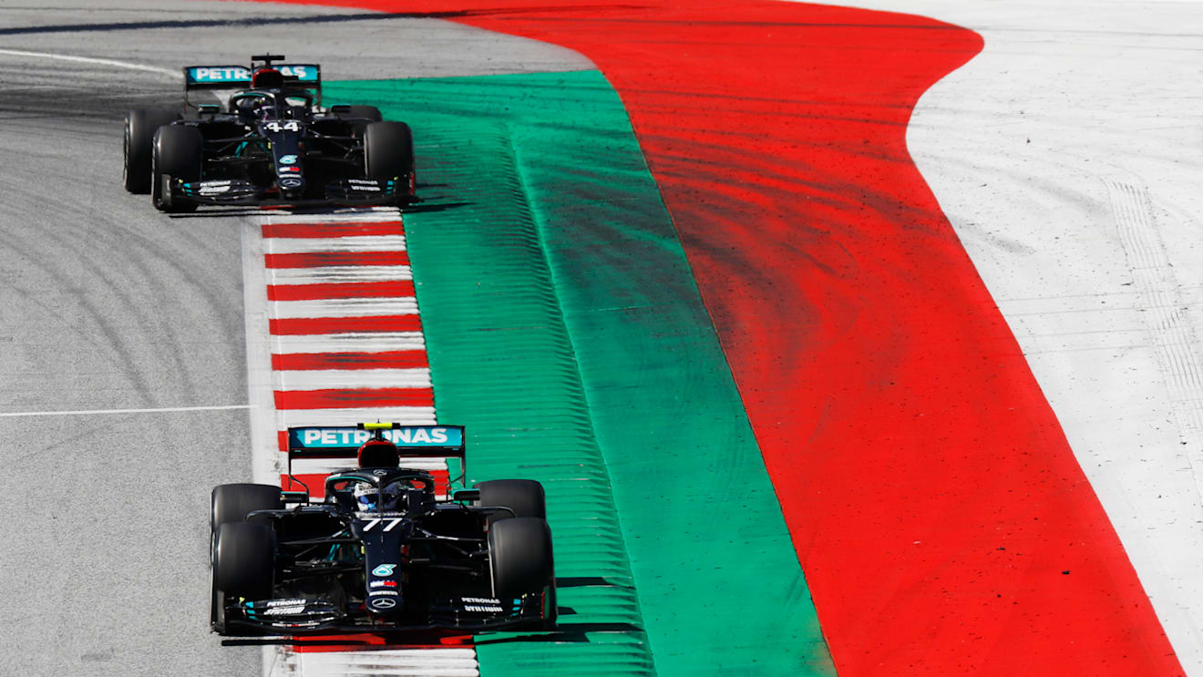 SPIELBERG, AUSTRIA - JULY 05: Valtteri Bottas of Finland driving the (77) Mercedes AMG Petronas F1 Team Mercedes W11 leads teammate Lewis Hamilton of Great Britain driving the (44) Mercedes AMG Petronas F1 Team Mercedes W11 during the Formula One Grand Prix of Austria at Red Bull Ring on July 05, 2020 in Spielberg, Austria. (Photo by Leonhard Foeger/Pool via Getty Images)