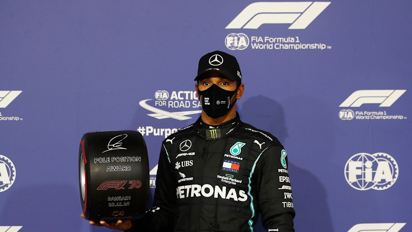 BAHRAIN, BAHRAIN - NOVEMBER 28: Pole position qualifier Lewis Hamilton of Great Britain and Mercedes GP poses with the pole position award in parc ferme during qualifying ahead of the F1 Grand Prix of Bahrain at Bahrain International Circuit on November 28, 2020 in Bahrain, Bahrain. (Photo by Hamad Mohammed - Pool/Getty Images)