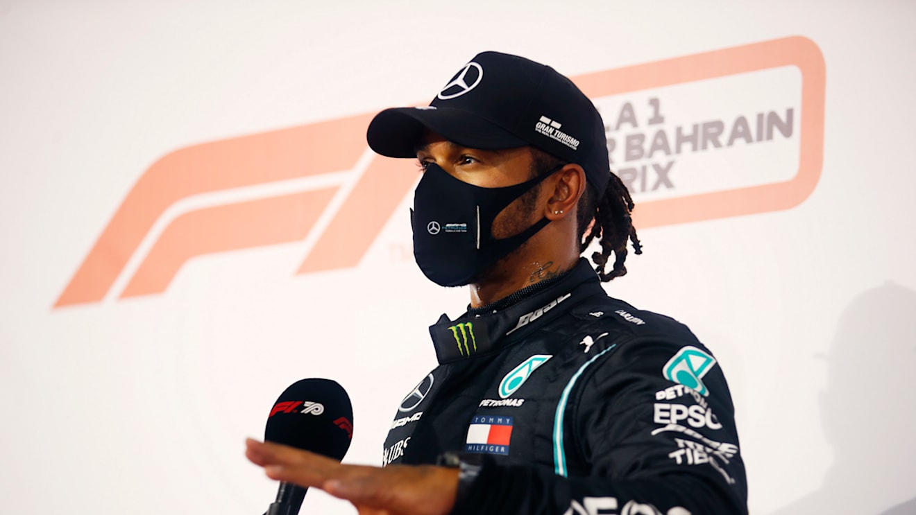 BAHRAIN, BAHRAIN - NOVEMBER 28: Pole position qualifier Lewis Hamilton of Great Britain and Mercedes GP talks to the media in parc ferme during qualifying ahead of the F1 Grand Prix of Bahrain at Bahrain International Circuit on November 28, 2020 in Bahrain, Bahrain. (Photo by Hamad Mohammed - Pool/Getty Images)