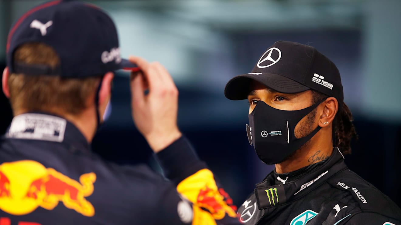 BAHRAIN, BAHRAIN - NOVEMBER 28: Pole position qualifier Lewis Hamilton of Great Britain and Mercedes GP speaks with third placed qualifier Max Verstappen of Netherlands and Red Bull Racing in parc ferme during qualifying ahead of the F1 Grand Prix of Bahrain at Bahrain International Circuit on November 28, 2020 in Bahrain, Bahrain. (Photo by Hamad Mohammed - Pool/Getty Images)