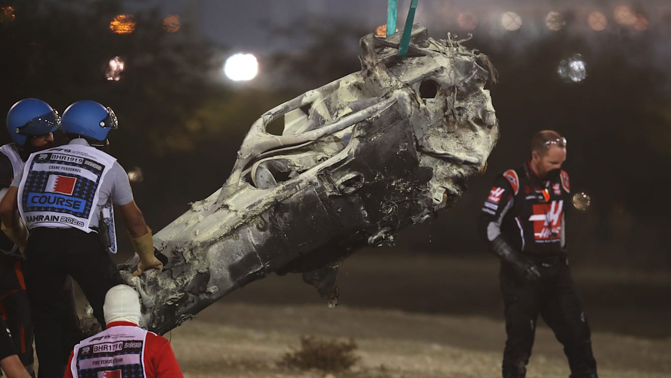 BAHRAIN, BAHRAIN - NOVEMBER 29: Track marshals clear the debris following the crash of Romain Grosjean of France and Haas F1 during the F1 Grand Prix of Bahrain at Bahrain International Circuit on November 29, 2020 in Bahrain, Bahrain. (Photo by Tolga Bozoglu - Pool/Getty Images)