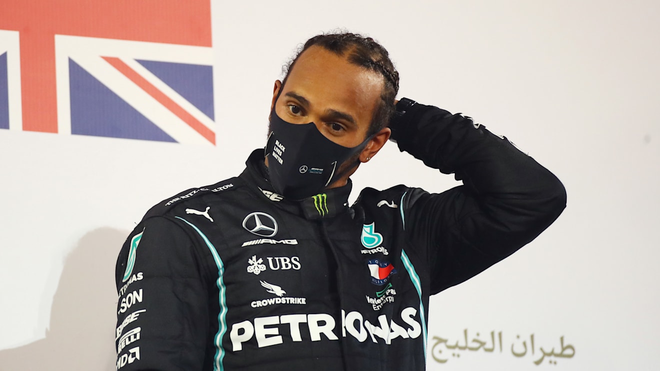 BAHRAIN, BAHRAIN - NOVEMBER 29: Race winner Lewis Hamilton of Great Britain and Mercedes GP celebrates on the podium during the F1 Grand Prix of Bahrain at Bahrain International Circuit on November 29, 2020 in Bahrain, Bahrain. (Photo by Bryn Lennon/Getty Images)