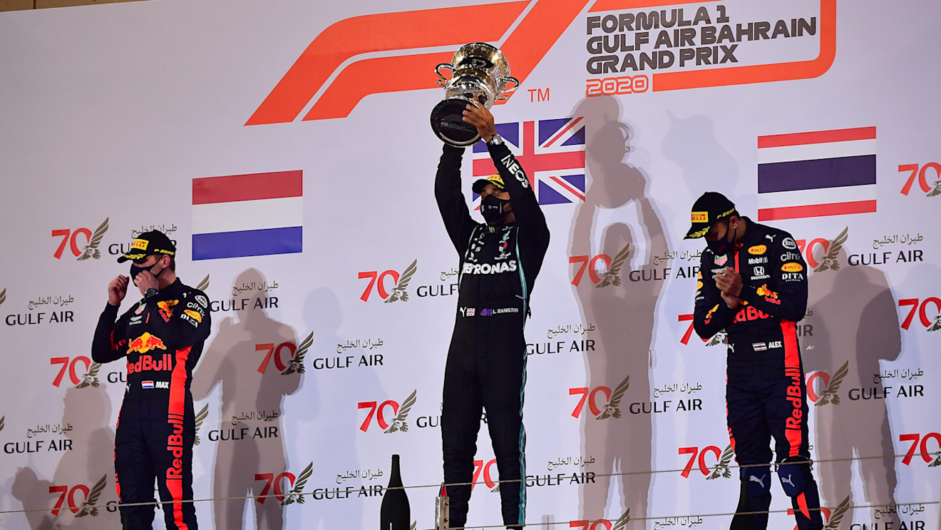 BAHRAIN, BAHRAIN - NOVEMBER 29: Race winner Lewis Hamilton of Great Britain and Mercedes GP, second placed Max Verstappen of Netherlands and Red Bull Racing and third placed Alexander Albon of Thailand and Red Bull Racing celebrate on the podium during the F1 Grand Prix of Bahrain at Bahrain International Circuit on November 29, 2020 in Bahrain, Bahrain. (Photo by Giuseppe Cacace - Pool/Getty Images)