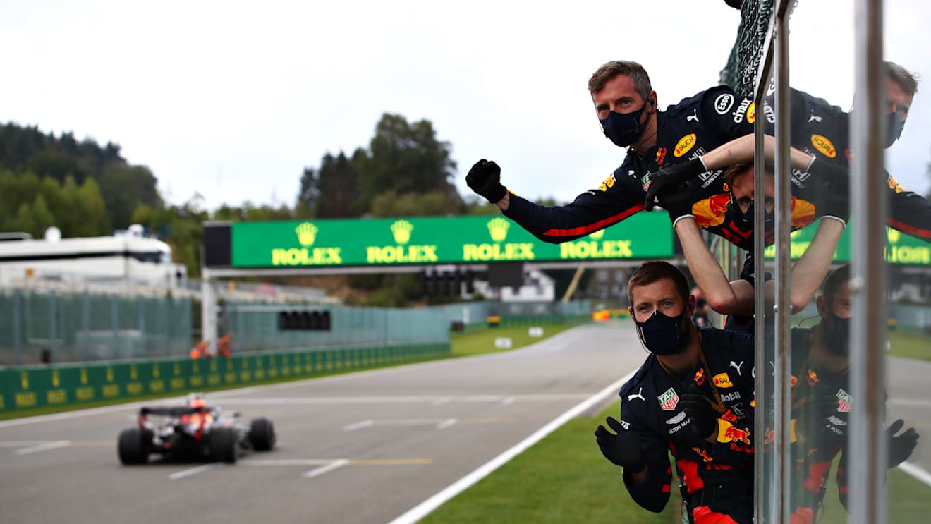 SPA, BELGIUM - AUGUST 30: Red Bull Racing team members celebrate on the pit wall as Max Verstappen of the Netherlands driving the (33) Aston Martin Red Bull Racing RB16 crosses the line to finish third during the F1 Grand Prix of Belgium at Circuit de Spa-Francorchamps on August 30, 2020 in Spa, Belgium. (Photo by Mark Thompson/Getty Images)