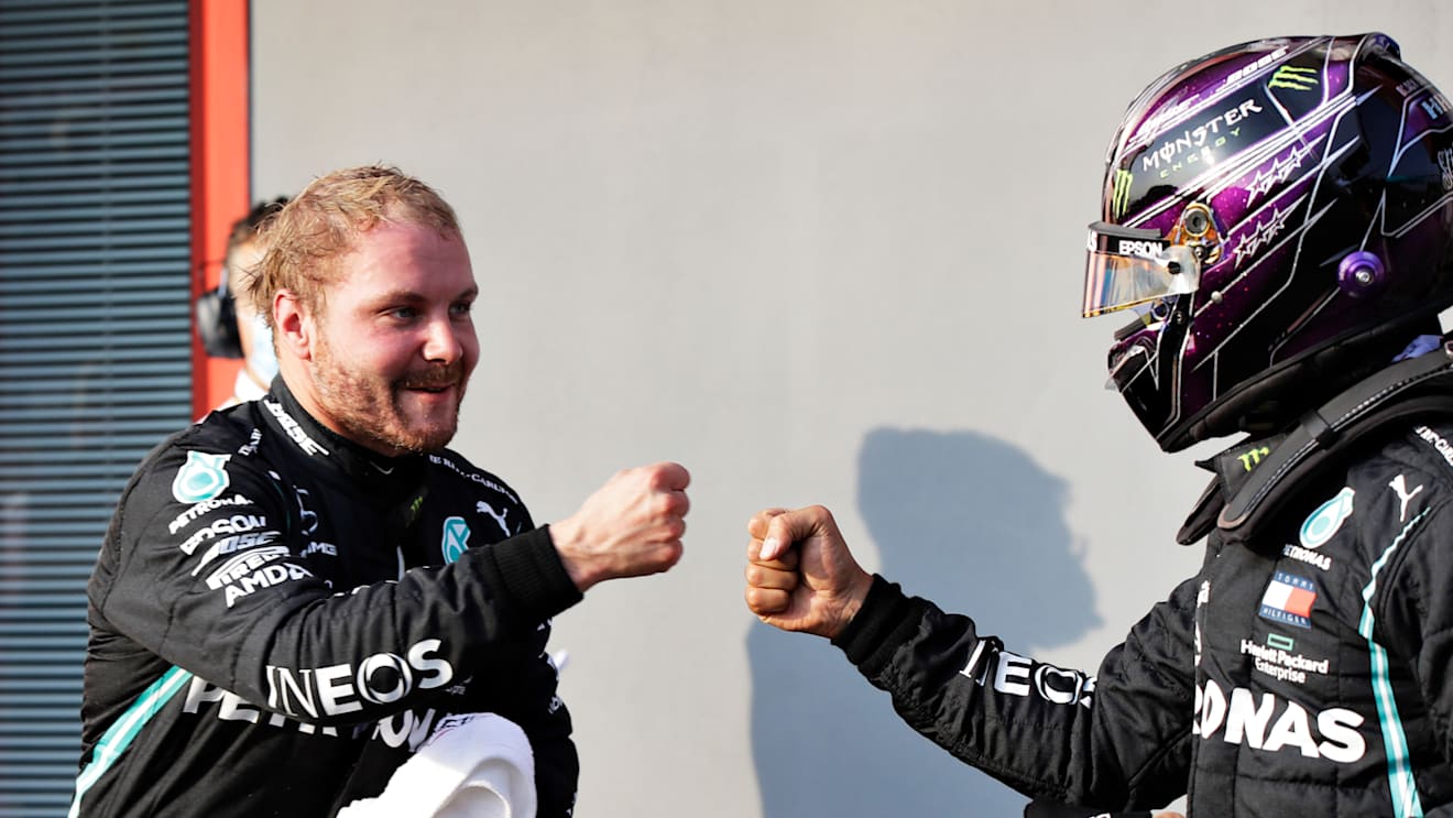 IMOLA, ITALY - OCTOBER 31: Pole position qualifier Valtteri Bottas of Finland and Mercedes GP bumps fists with second place qualifier Lewis Hamilton of Great Britain and Mercedes GP in parc ferme in parc ferme during qualifying ahead of the F1 Grand Prix of Emilia Romagna at Autodromo Enzo e Dino Ferrari on October 31, 2020 in Imola, Italy. (Photo by Luca Bruno - Pool/Getty Images)