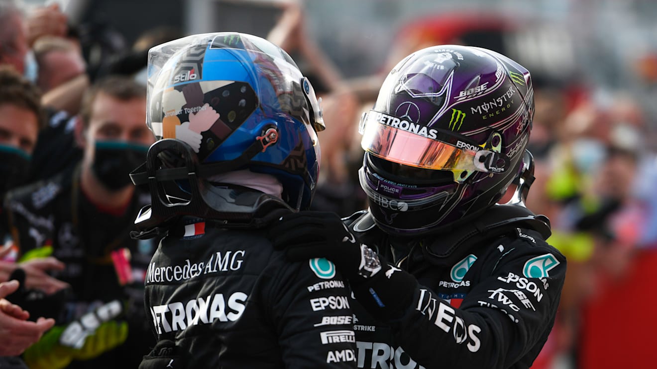 IMOLA, ITALY - NOVEMBER 01: Race winner Lewis Hamilton of Great Britain and Mercedes GP (R) embraces teammate and second placed Valtteri Bottas of Finland and Mercedes GP (L) in parc ferme during the F1 Grand Prix of Emilia Romagna at Autodromo Enzo e Dino Ferrari on November 01, 2020 in Imola, Italy. (Photo by Rudy Carezzevoli/Getty Images)