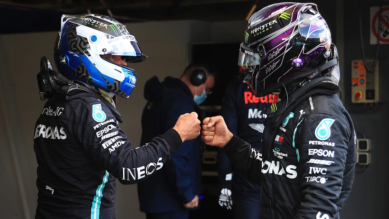 NUERBURG, GERMANY - OCTOBER 10: Second placed qualifier Lewis Hamilton of Great Britain and Mercedes GP and pole position qualifier Valtteri Bottas of Finland and Mercedes GP embrace in parc ferme during qualifying ahead of the F1 Eifel Grand Prix at Nuerburgring on October 10, 2020 in Nuerburg, Germany. (Photo by Wolfgang Rattay - Pool/Getty Images)