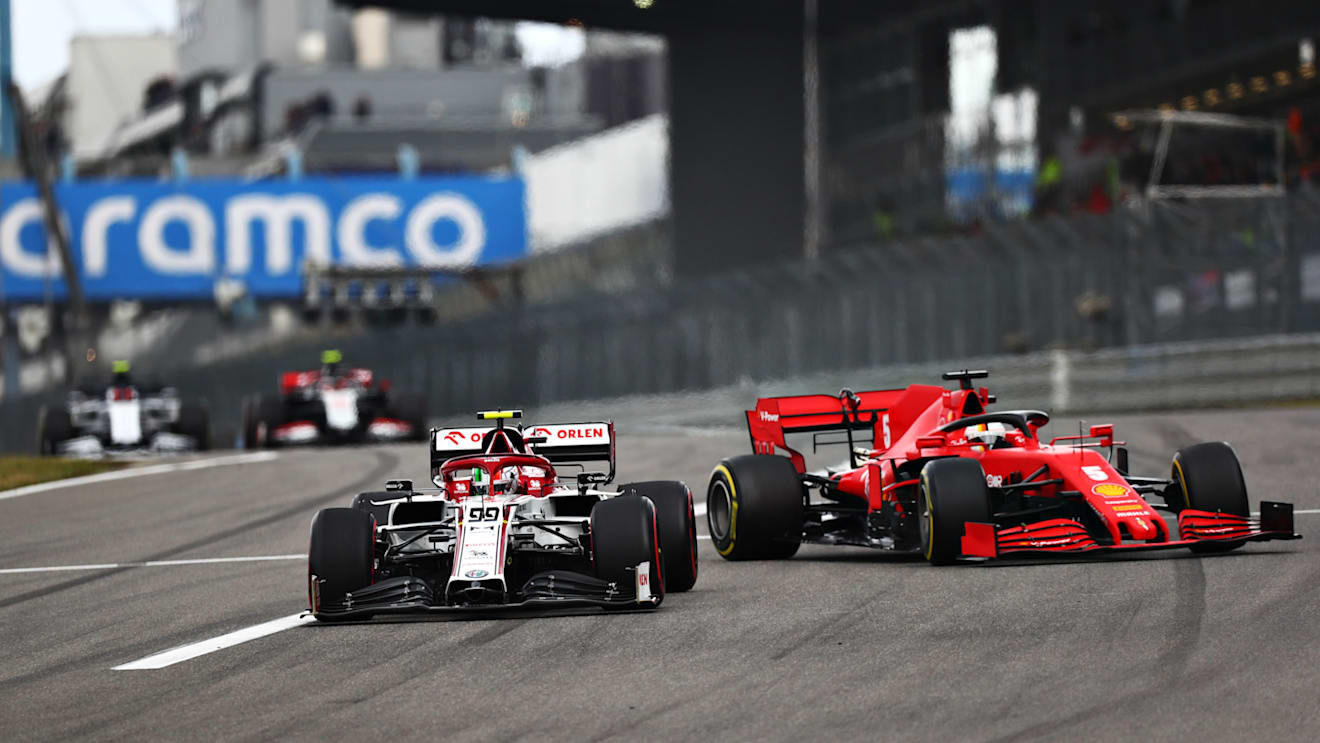 NUERBURG, GERMANY - OCTOBER 11: Antonio Giovinazzi of Italy driving the (99) Alfa Romeo Racing C39 Ferrari as Sebastian Vettel of Germany driving the (5) Scuderia Ferrari SF1000 behind loses control into the corner during the F1 Eifel Grand Prix at Nuerburgring on October 11, 2020 in Nuerburg, Germany. (Photo by Dan Istitene - Formula 1/Formula 1 via Getty Images)