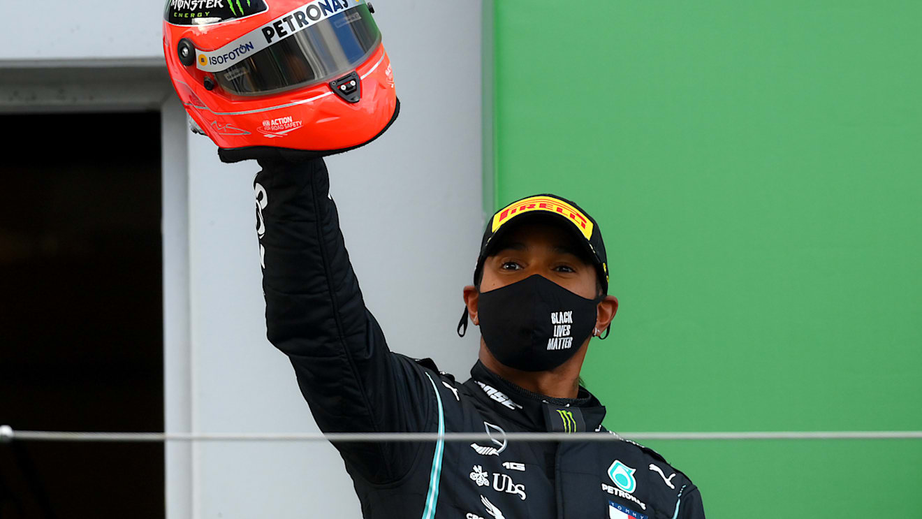 NUERBURG, GERMANY - OCTOBER 11: Race winner Lewis Hamilton of Great Britain and Mercedes GP celebrates after being presented with a helmet of Michael Schumacher for matching his record of 91 race wins during the F1 Eifel Grand Prix at Nuerburgring on October 11, 2020 in Nuerburg, Germany. (Photo by Clive Mason - Formula 1/Formula 1 via Getty Images)