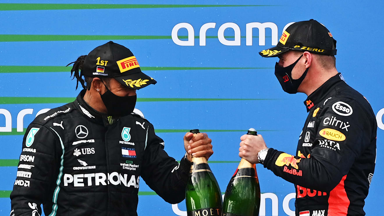 NUERBURG, GERMANY - OCTOBER 11: Race winner Lewis Hamilton of Great Britain and Mercedes GP and second placed Max Verstappen of Netherlands and Red Bull Racing celebrate on the podium during the F1 Eifel Grand Prix at Nuerburgring on October 11, 2020 in Nuerburg, Germany. (Photo by Ina Fassbender - Pool/Getty Images)