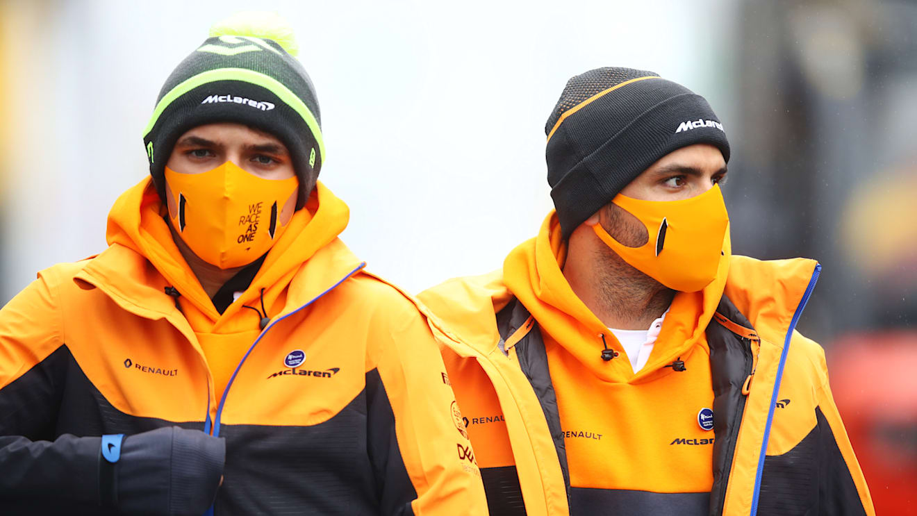 NUERBURG, GERMANY - OCTOBER 08: Lando Norris of Great Britain and McLaren F1 and Carlos Sainz of Spain and McLaren F1 walk in the Paddock during previews ahead of the F1 Eifel Grand Prix at Nuerburgring on October 08, 2020 in Nuerburg, Germany. (Photo by Mark Thompson/Getty Images)