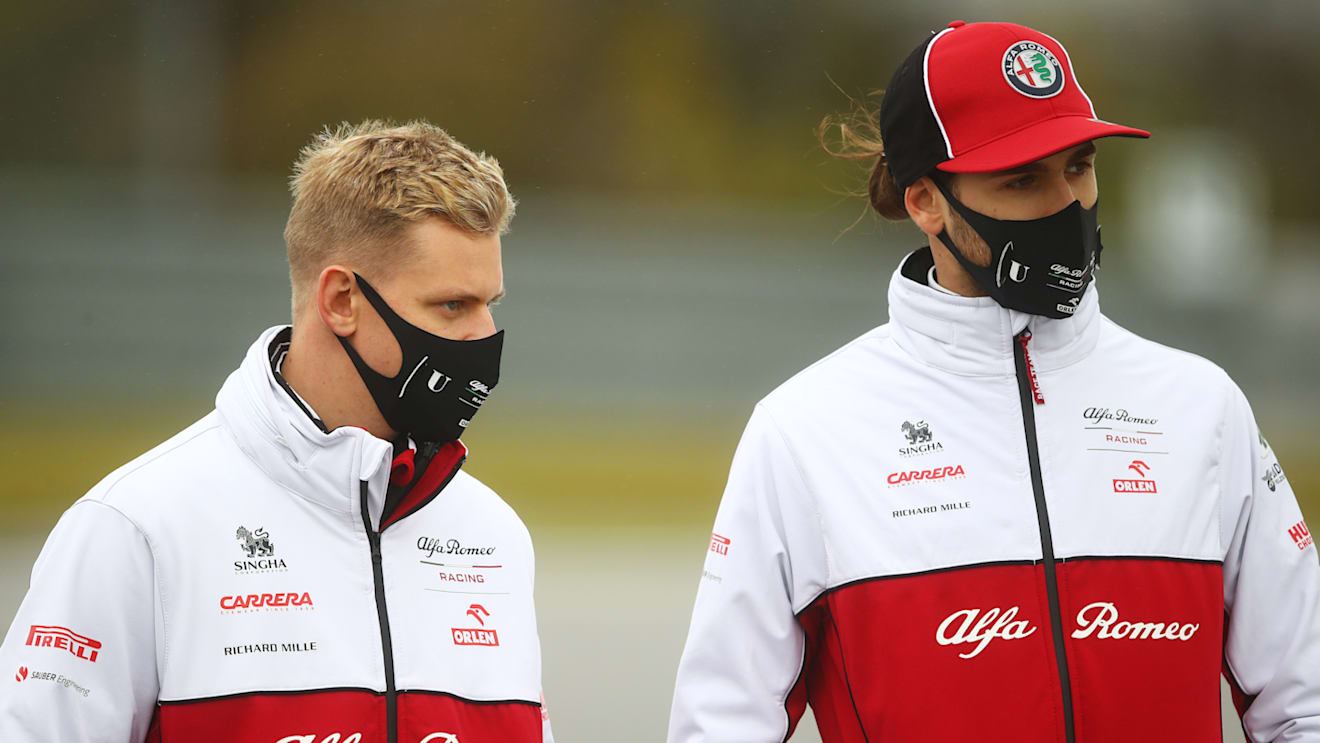 NUERBURG, GERMANY - OCTOBER 08: Mick Schumacher of Germany and Alfa Romeo Racing talks with Antonio Giovinazzi of Italy and Alfa Romeo Racing on a track walk during previews ahead of the F1 Eifel Grand Prix at Nuerburgring on October 08, 2020 in Nuerburg, Germany. (Photo by Bryn Lennon/Getty Images)