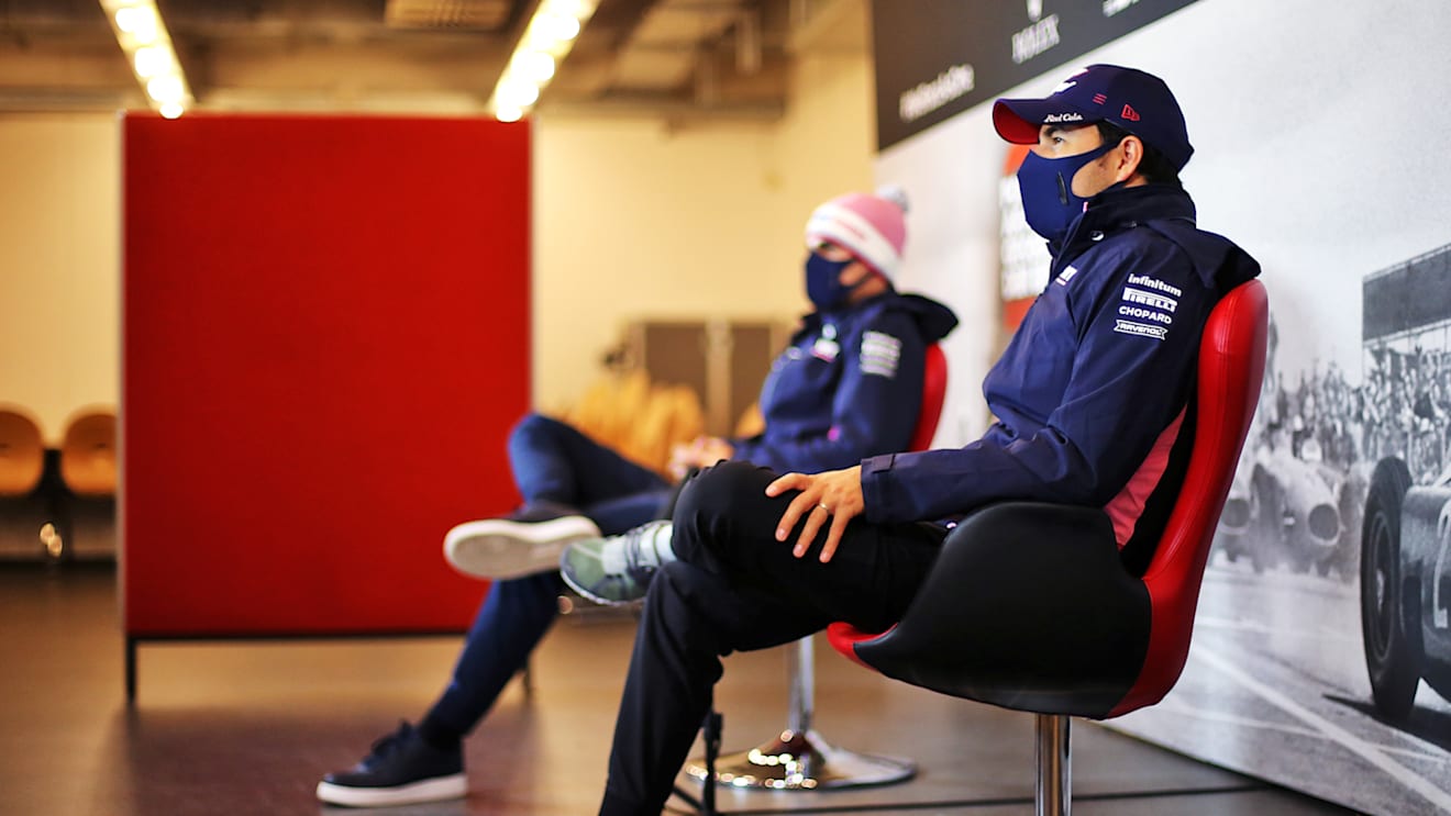NUERBURG, GERMANY - OCTOBER 08: Lance Stroll of Canada and Racing Point and Sergio Perez of Mexico and Racing Point talk in the Drivers Press Conference during previews ahead of the F1 Eifel Grand Prix at Nuerburgring on October 08, 2020 in Nuerburg, Germany. (Photo by XPB - Pool/Getty Images)
