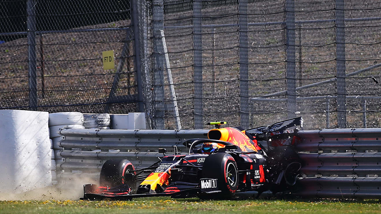 NORTHAMPTON, ENGLAND - JULY 31: Alexander Albon of Thailand driving the (23) Aston Martin Red Bull Racing RB16 crashes into a track barrier during practice for the F1 Grand Prix of Great Britain at Silverstone on July 31, 2020 in Northampton, England. (Photo by Bryn Lennon/Getty Images)
