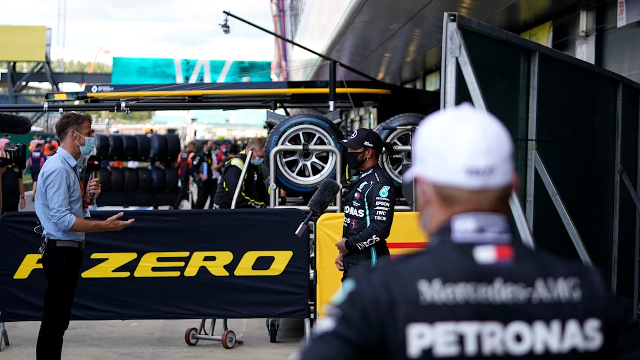 NORTHAMPTON, ENGLAND - AUGUST 01: Pole position qualifier Lewis Hamilton of Great Britain and Mercedes GP talks to the media in parc ferme during qualifying for the F1 Grand Prix of Great Britain at Silverstone on August 01, 2020 in Northampton, England. (Photo by Will Oliver/Pool via Getty Images)