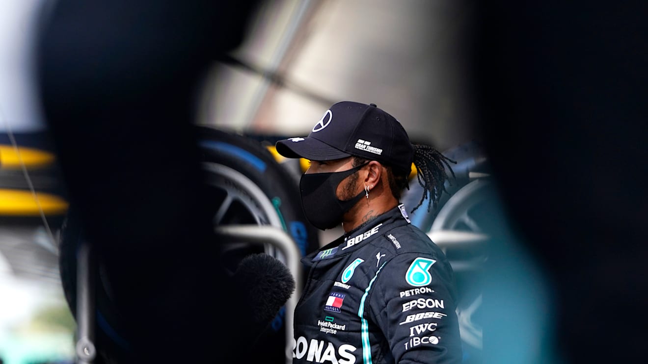 NORTHAMPTON, ENGLAND - AUGUST 01: Pole position qualifier Lewis Hamilton of Great Britain and Mercedes GP talks to the media in parc ferme during qualifying for the F1 Grand Prix of Great Britain at Silverstone on August 01, 2020 in Northampton, England. (Photo by Will Oliver/Pool via Getty Images)