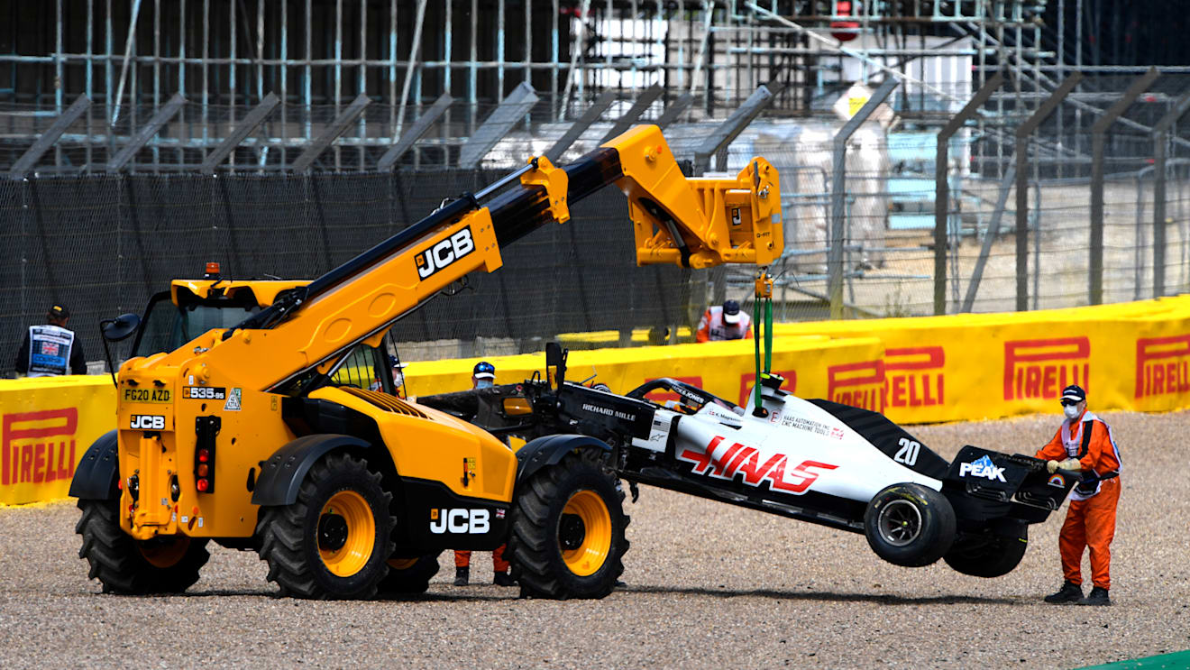 NORTHAMPTON, ENGLAND - AUGUST 02: The car of Kevin Magnussen of Denmark and Haas F1 is taken away after spinning off during the F1 Grand Prix of Great Britain at Silverstone on August 02, 2020 in Northampton, England. (Photo by Rudy Carezzevoli/Getty Images)