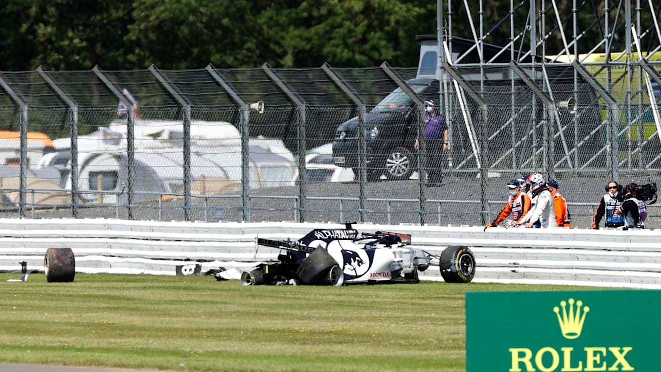 NORTHAMPTON, ENGLAND - AUGUST 02: Daniil Kvyat of Russia and Scuderia AlphaTauri looks at his car after crashing into a track barrier during the F1 Grand Prix of Great Britain at Silverstone on August 02, 2020 in Northampton, England. (Photo by Andrew Boyers/Pool via Getty Images)