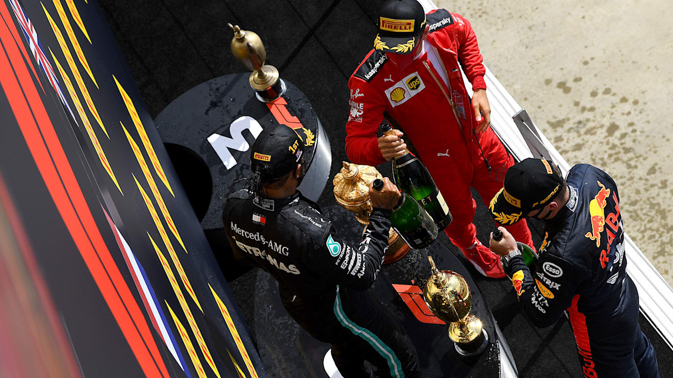 NORTHAMPTON, ENGLAND - AUGUST 02: Race winner Lewis Hamilton of Great Britain and Mercedes GP, second placed Max Verstappen of Netherlands and Red Bull Racing and third placed Charles Leclerc of Monaco and Ferrari celebrate on the podium during the F1 Grand Prix of Great Britain at Silverstone on August 02, 2020 in Northampton, England. (Photo by Clive Mason - Formula 1/Formula 1 via Getty Images)