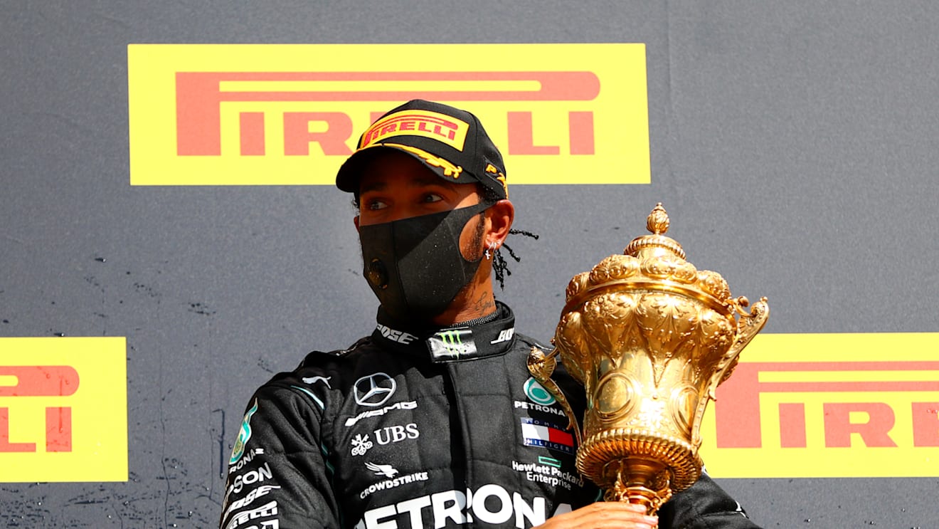 NORTHAMPTON, ENGLAND - AUGUST 02: Lewis Hamilton of Great Britain and Mercedes GP celebrates on the podium after winning the Formula One Grand Prix of Hungary at Silverstone on August 02, 2020 in Northampton, England. (Photo by Dan Istitene - Formula 1/Formula 1 via Getty Images)
