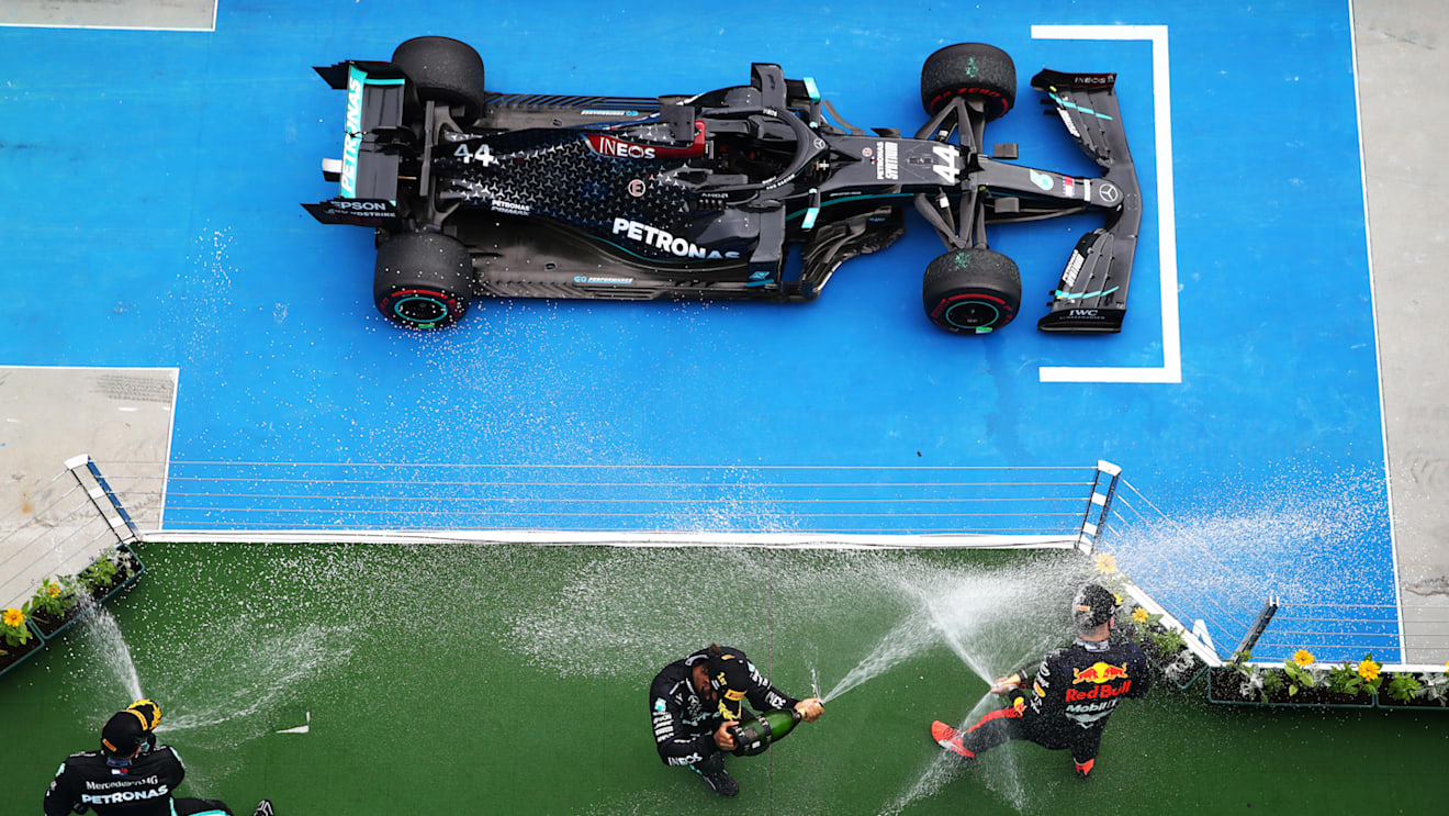 BUDAPEST, HUNGARY - JULY 19: Race winner Lewis Hamilton of Great Britain and Mercedes GP, second placed Max Verstappen of Netherlands and Red Bull Racing and third placed Valtteri Bottas of Finland and Mercedes GP celebrate on the podium after the Formula One Grand Prix of Hungary at Hungaroring on July 19, 2020 in Budapest, Hungary. (Photo by Mark Thompson/Getty Images)