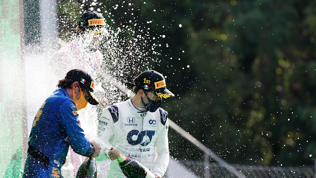 MONZA, ITALY - SEPTEMBER 06: Race winner Pierre Gasly of France and Scuderia AlphaTauri and second placed Carlos Sainz of Spain and McLaren F1 celebrate on the podium during the F1 Grand Prix of Italy at Autodromo di Monza on September 06, 2020 in Monza, Italy. (Photo by Luca Bruno - Pool/Getty Images)