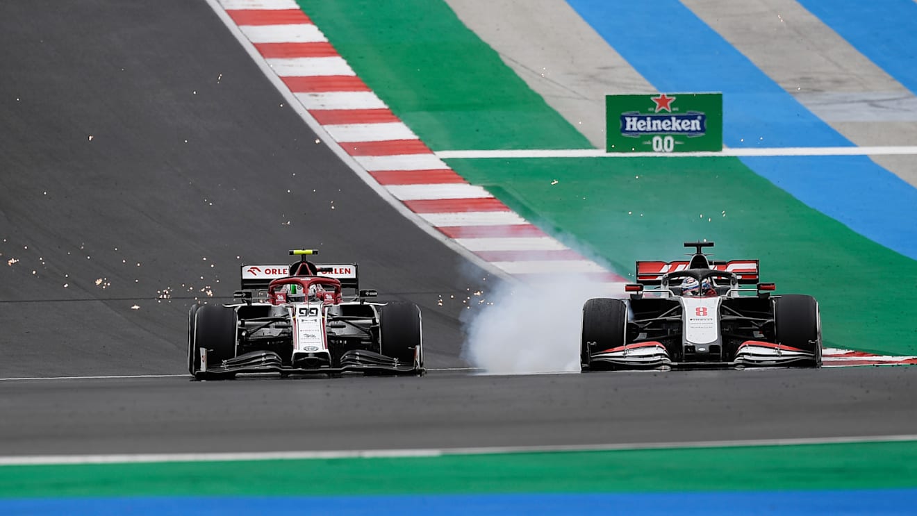 PORTIMAO, PORTUGAL - OCTOBER 25: Antonio Giovinazzi of Italy driving the (99) Alfa Romeo Racing C39 Ferrari and Romain Grosjean of France driving the (8) Haas F1 Team VF-20 Ferrari battle for position on track during the F1 Grand Prix of Portugal at Autodromo Internacional do Algarve on October 25, 2020 in Portimao, Portugal. (Photo by Jorge Guerrero - Pool/Getty Images)