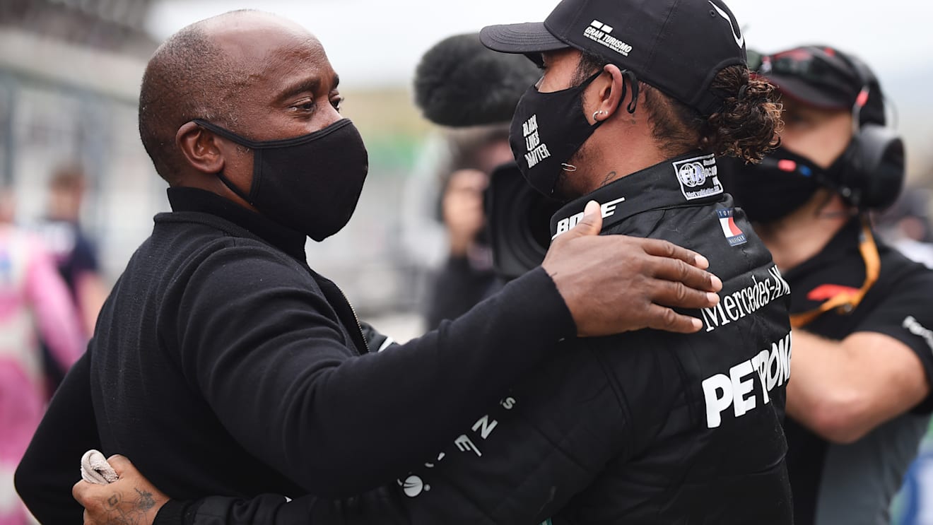 PORTIMAO, PORTUGAL - OCTOBER 25: Race winner Lewis Hamilton of Great Britain and Mercedes GP celebrates his record breaking 92nd race win with his father Anthony Hamilton in parc ferme during the F1 Grand Prix of Portugal at Autodromo Internacional do Algarve on October 25, 2020 in Portimao, Portugal. (Photo by Jorge Guerrero - Pool/Getty Images)