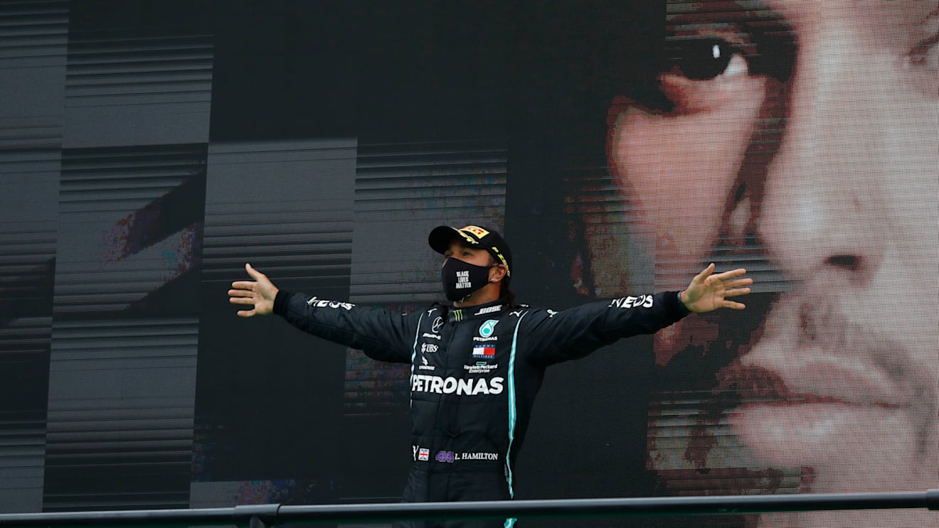 PORTIMAO, PORTUGAL - OCTOBER 25: Race winner Lewis Hamilton of Great Britain and Mercedes GP celebrates his record breaking 92nd race win on the podium during the F1 Grand Prix of Portugal at Autodromo Internacional do Algarve on October 25, 2020 in Portimao, Portugal. (Photo by Rafael Marchante - Pool/Getty Images)