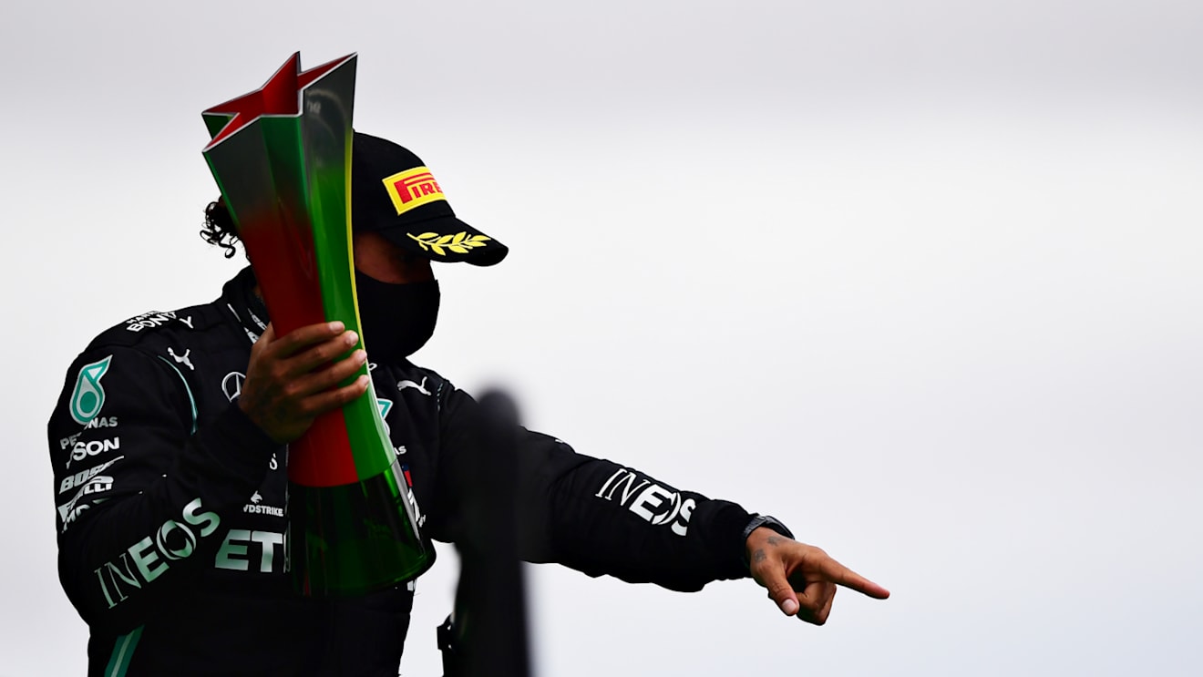PORTIMAO, PORTUGAL - OCTOBER 25: Race winner Lewis Hamilton of Great Britain and Mercedes GP celebrates his record breaking 92nd race win on the podium during the F1 Grand Prix of Portugal at Autodromo Internacional do Algarve on October 25, 2020 in Portimao, Portugal. (Photo by Mario Renzi - Formula 1/Formula 1 via Getty Images)