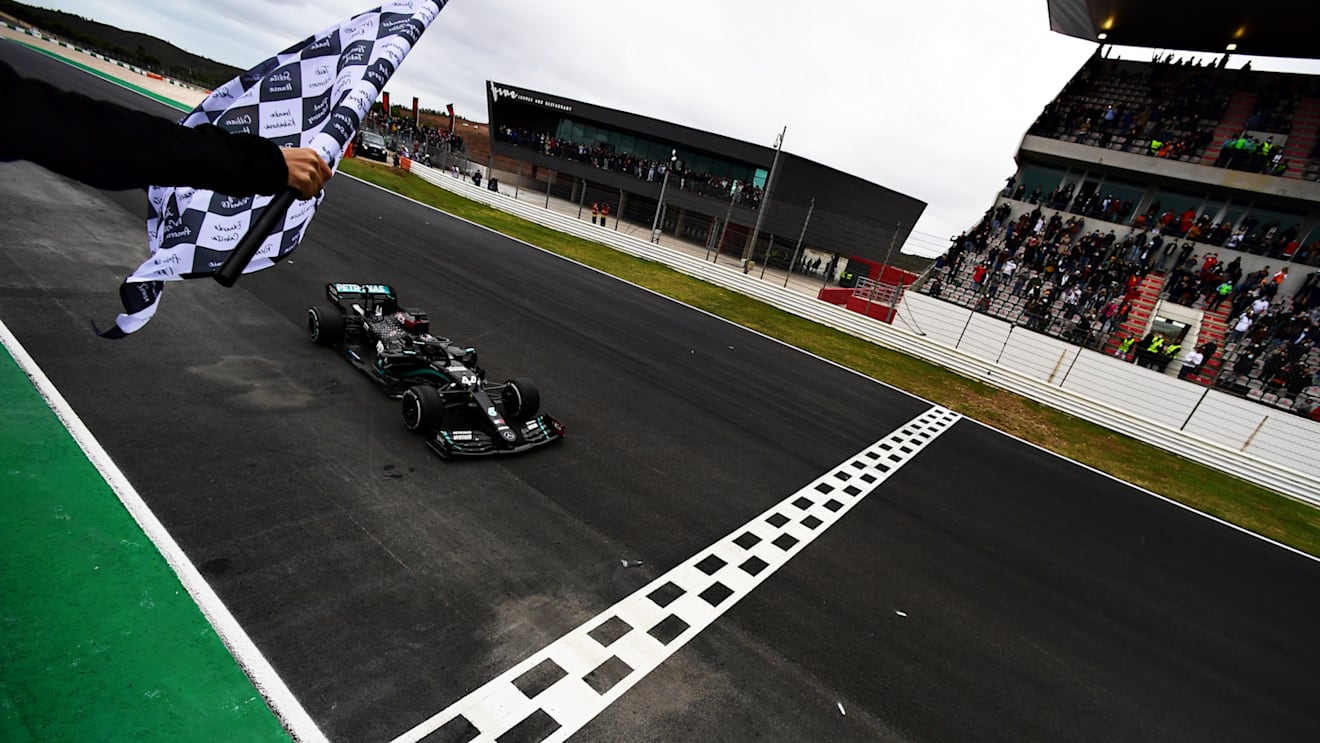 PORTIMAO, PORTUGAL - OCTOBER 25: Race winner Lewis Hamilton of Great Britain driving the (44) Mercedes AMG Petronas F1 Team Mercedes W11 takes the chequered flag for his record breaking 92nd race win during the F1 Grand Prix of Portugal at Autodromo Internacional do Algarve on October 25, 2020 in Portimao, Portugal. (Photo by Mario Renzi - Formula 1/Formula 1 via Getty Images)