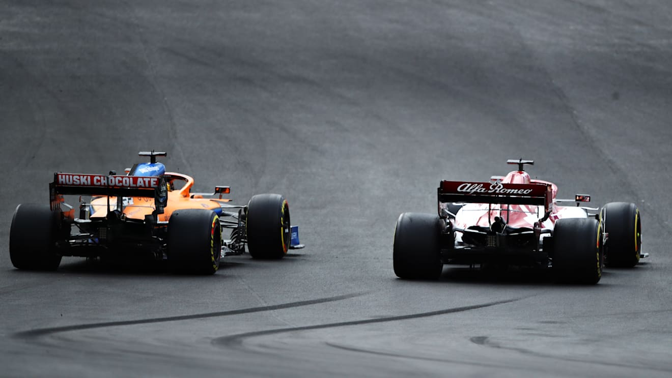 PORTIMAO, PORTUGAL - OCTOBER 25: Carlos Sainz of Spain driving the (55) McLaren F1 Team MCL35 Renault and Kimi Raikkonen of Finland driving the (7) Alfa Romeo Racing C39 Ferrari battle for track position during the F1 Grand Prix of Portugal at Autodromo Internacional do Algarve on October 25, 2020 in Portimao, Portugal. (Photo by Bryn Lennon - Formula 1/Formula 1 via Getty Images)